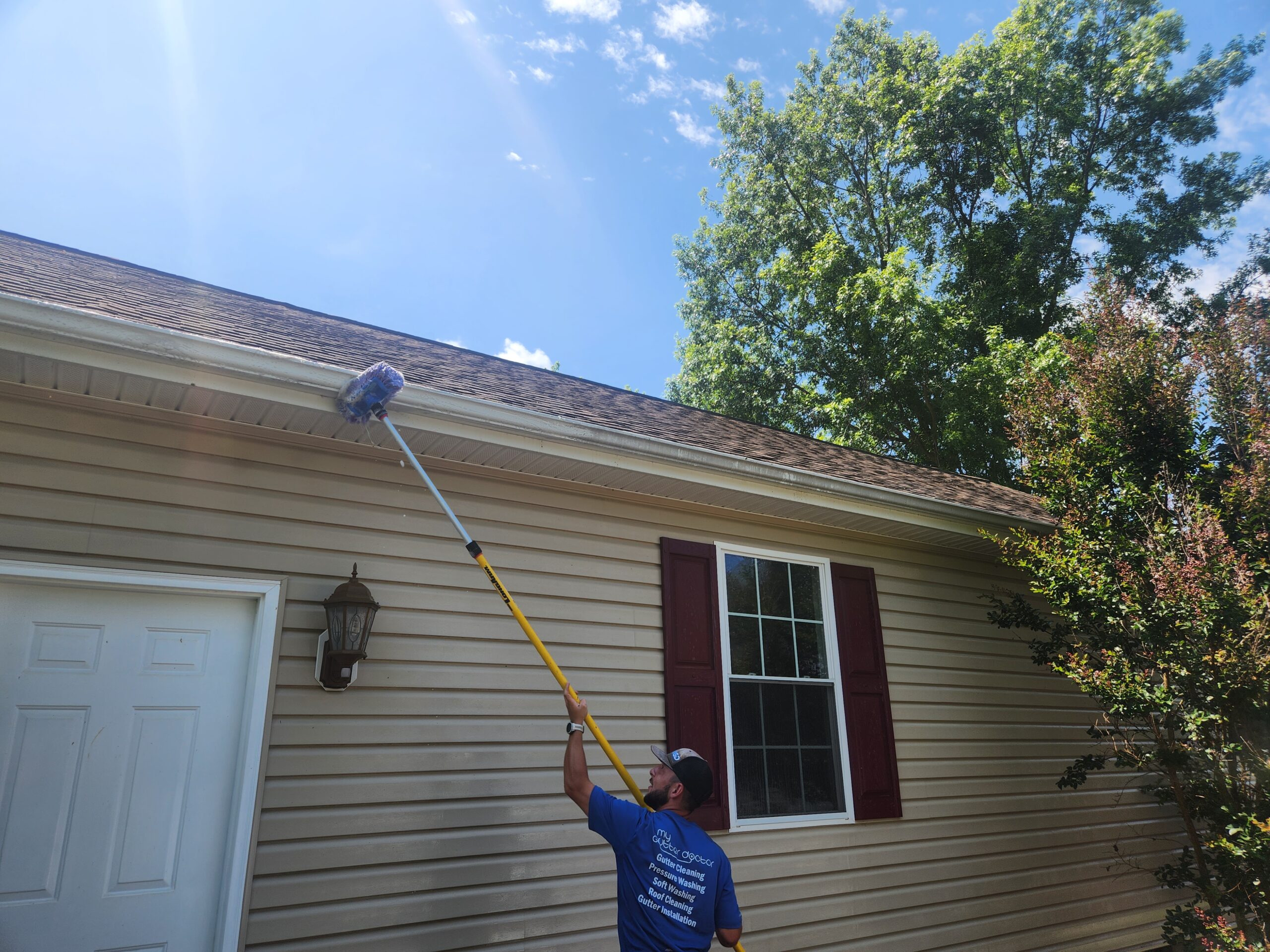 scrubbing gutter with brush