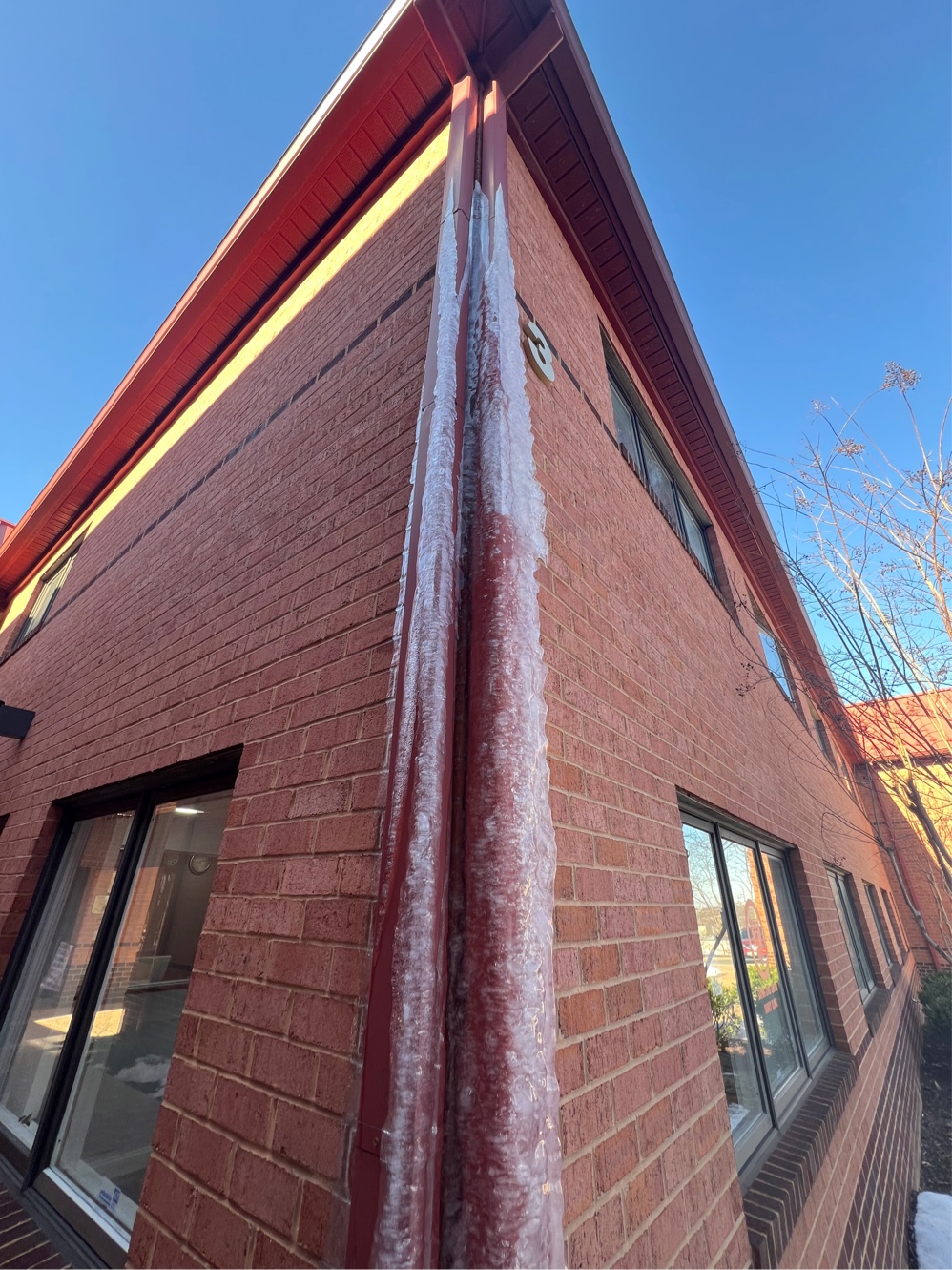 frozen downspout encased in ice