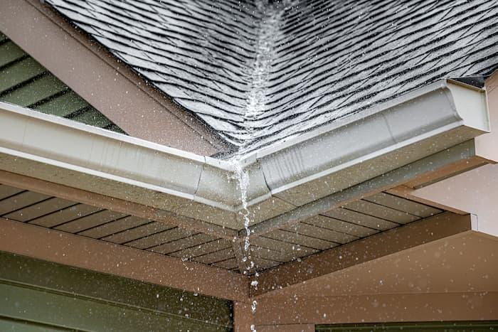 water from roof valley overflows gutter corner