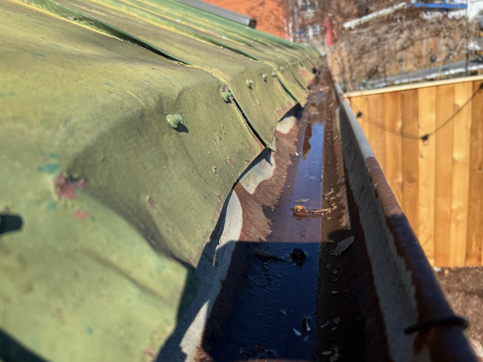 metal roof overhang tucked over the gutter