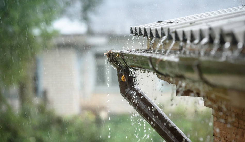 water from metal roof overshoots gutter