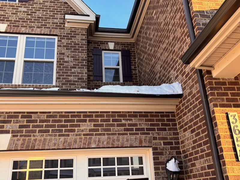 snow from metal roof causes damage to a gutter