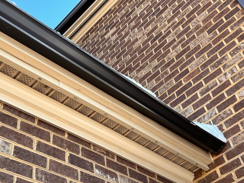 snow avalanche damages gutter under metal roof