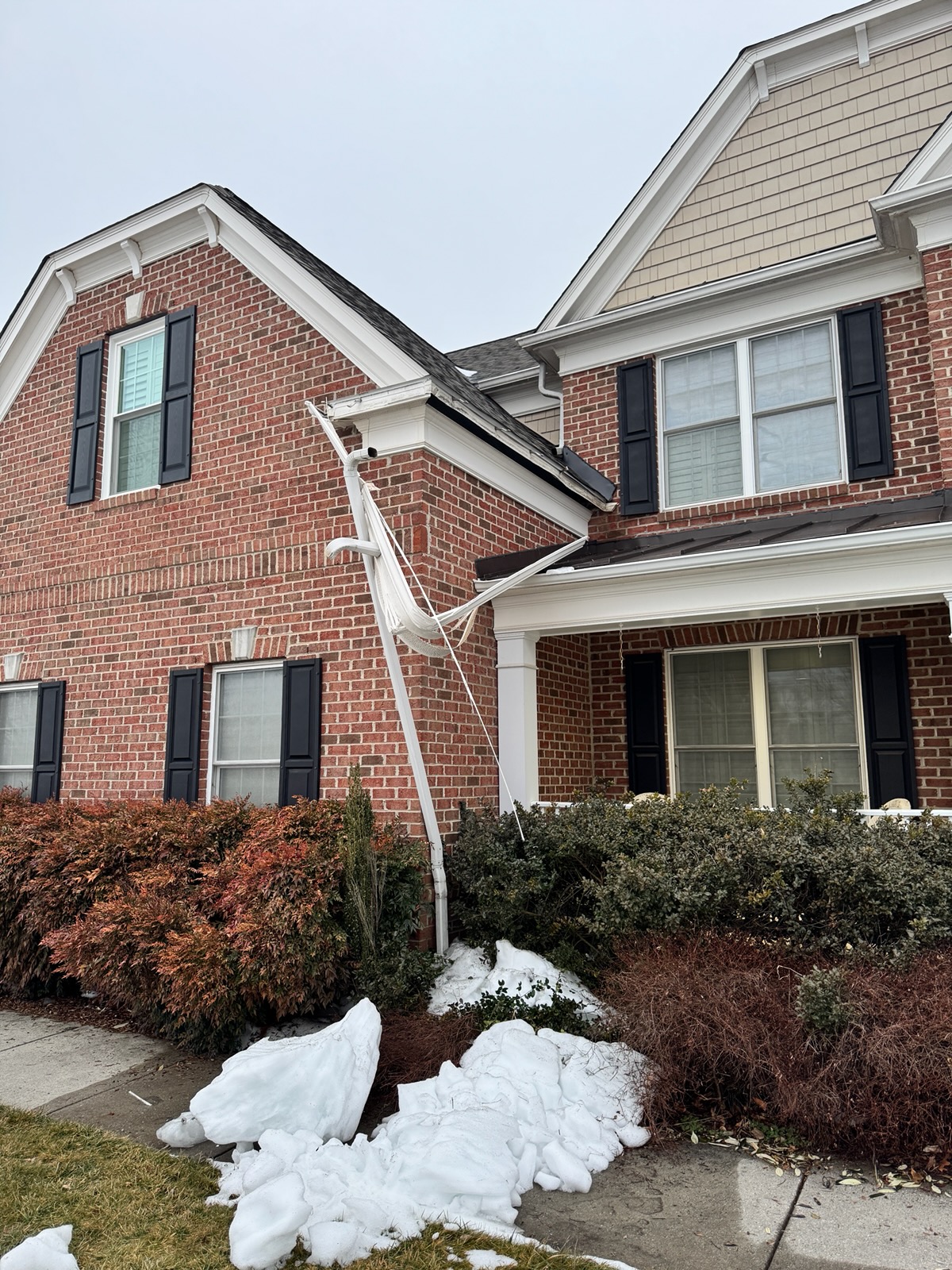 roof avalanche rips gutter fascia and soffit off of the house